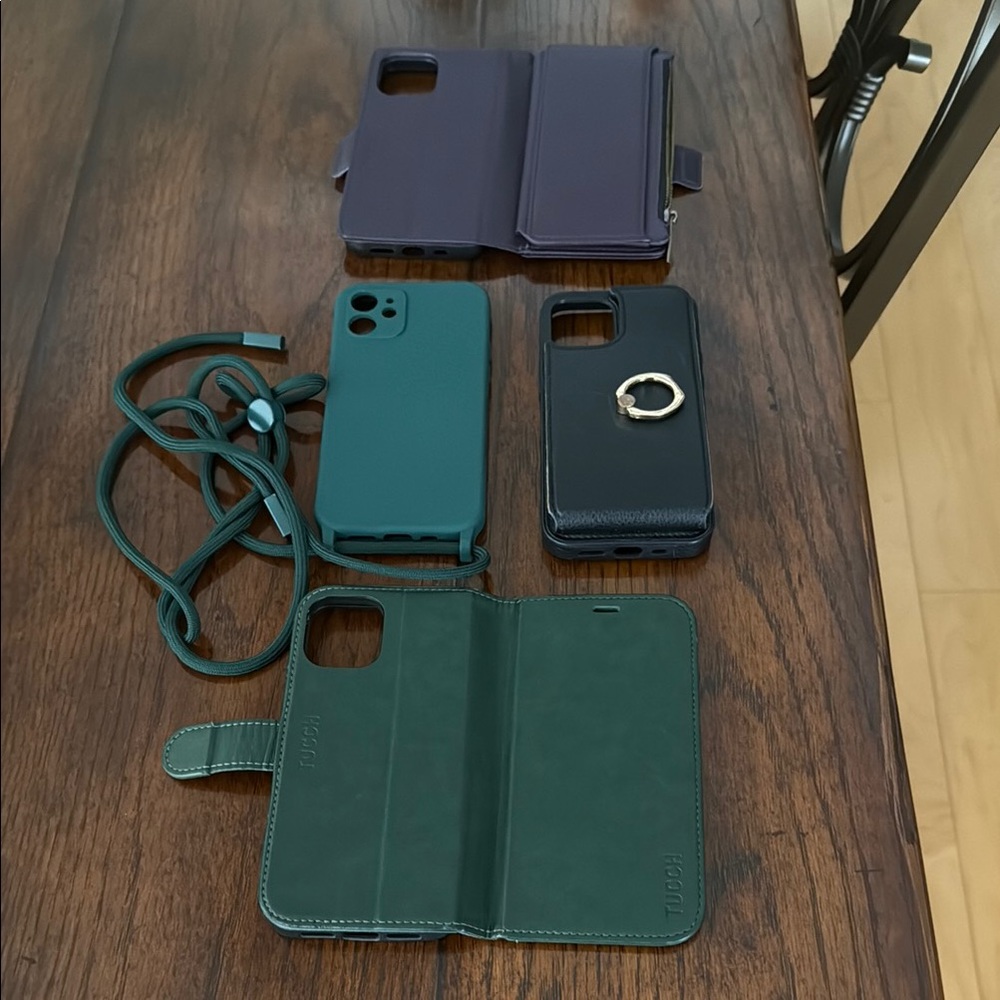 Four iPhone 12 cases. One purple two green one black.